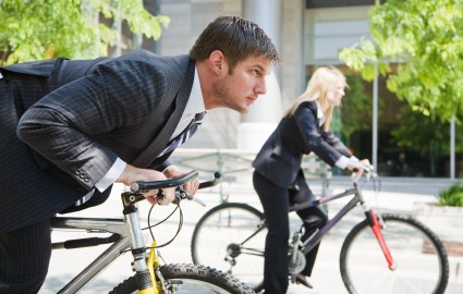 Business people racing on bicycles